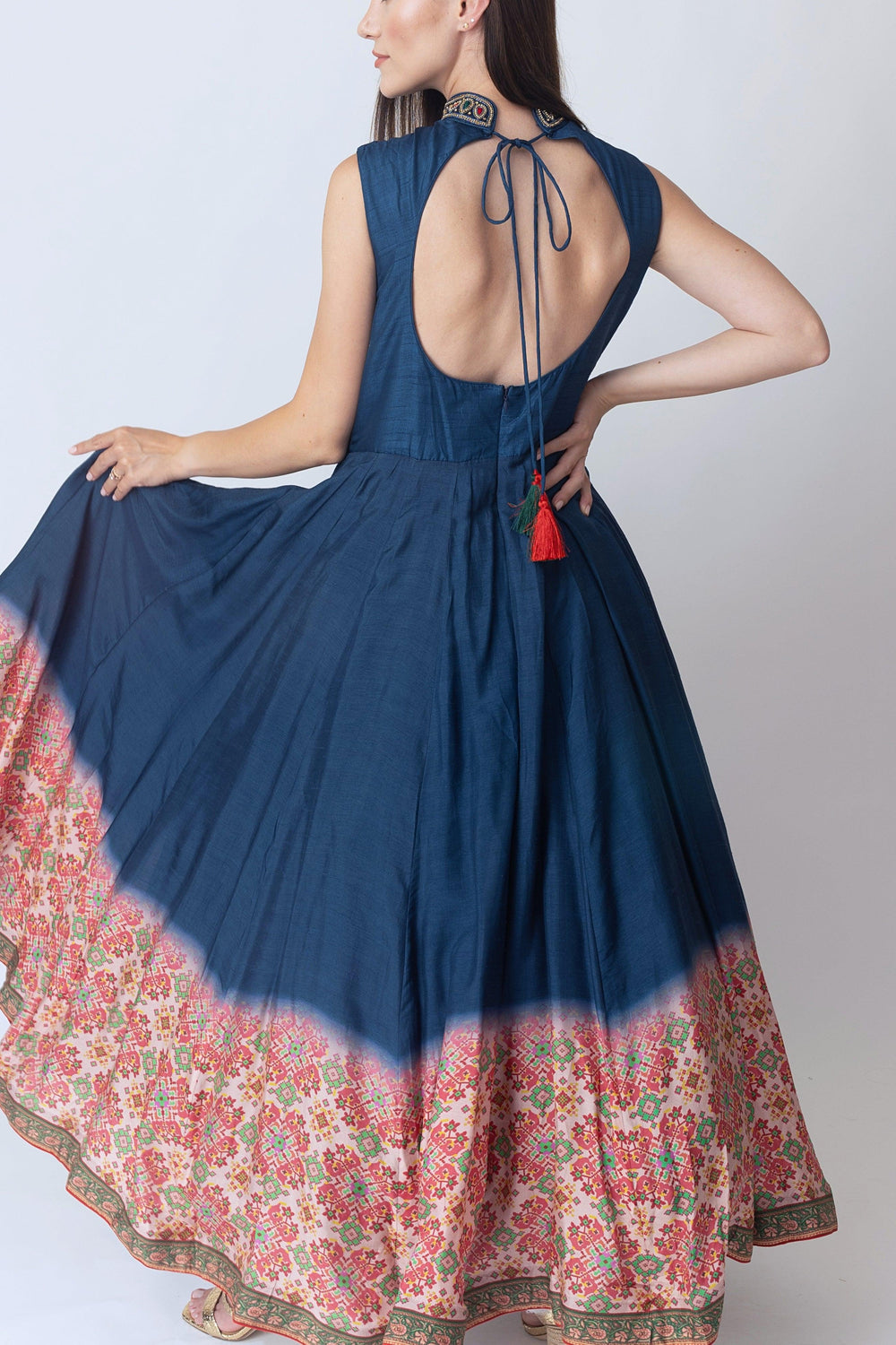 Navy raw silk gown with intricate embroidery, open back, and Patola print hem.