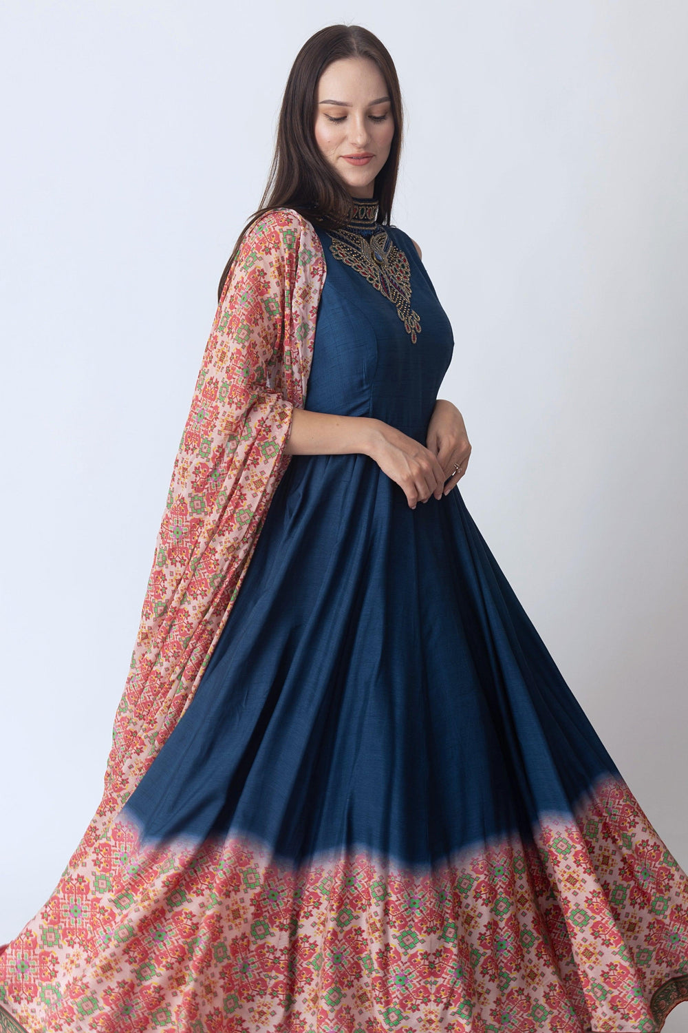 Navy raw silk gown with intricate hand embroidery, Patola print hem, and coordinating drape.