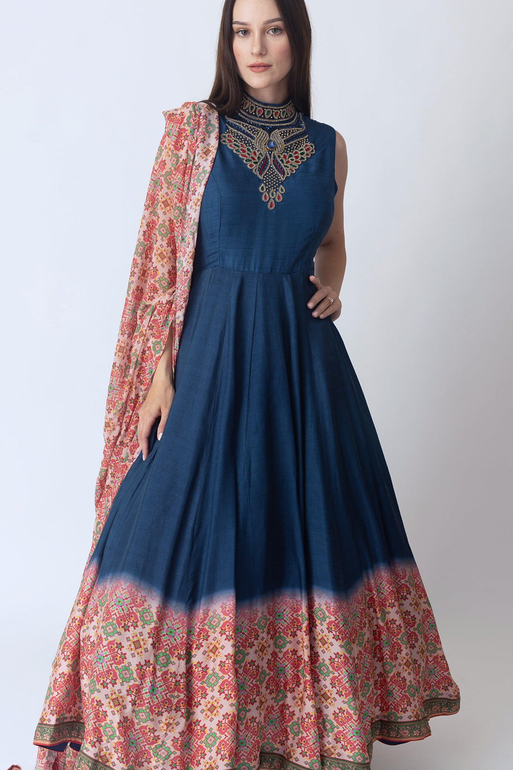 Navy raw silk gown with intricate hand embroidery on the torso and Patola print at the hem, paired with a matching drape.