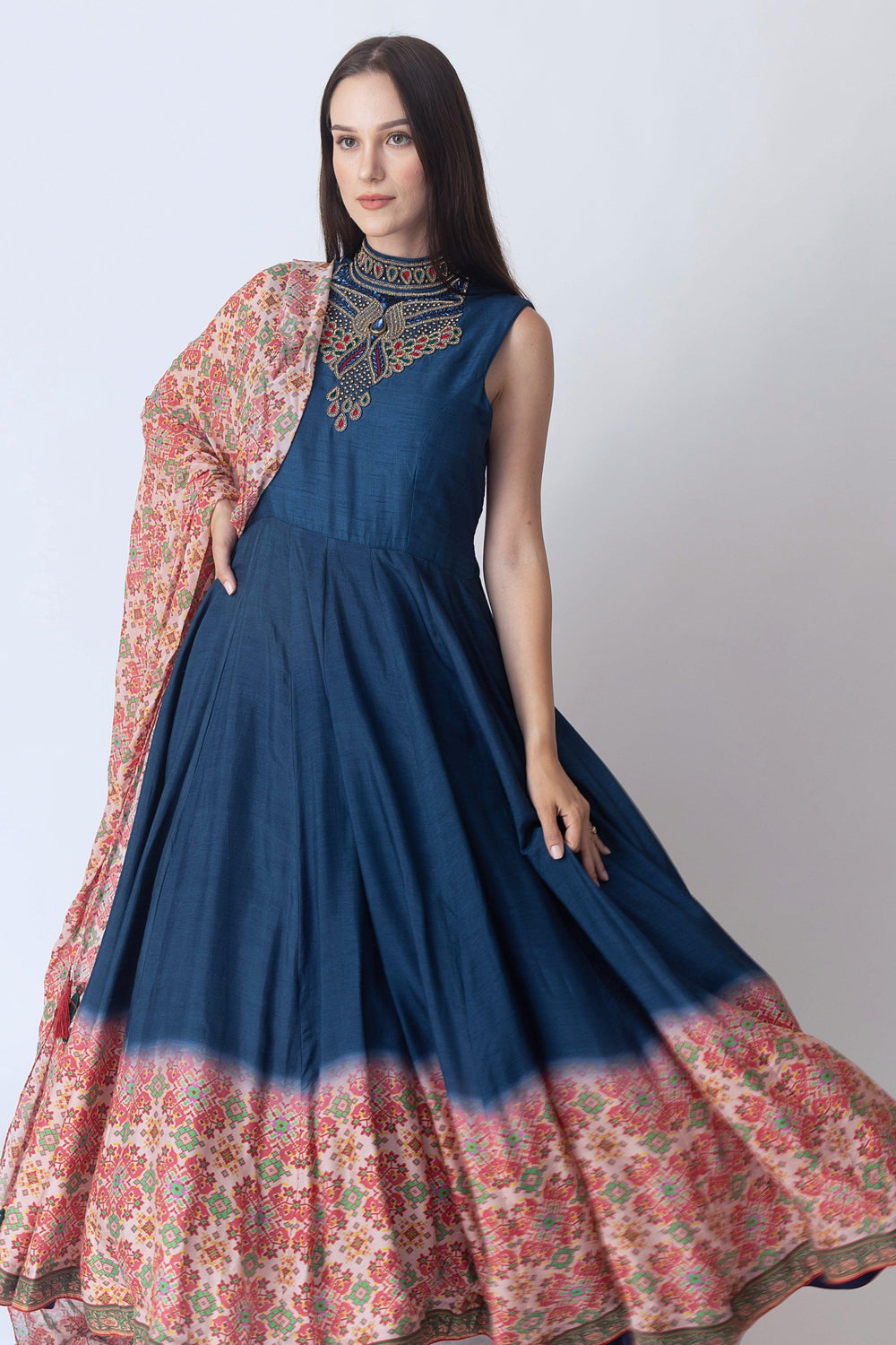 Navy raw silk gown with intricate hand embroidery, Patola print hem, and coordinating drape.