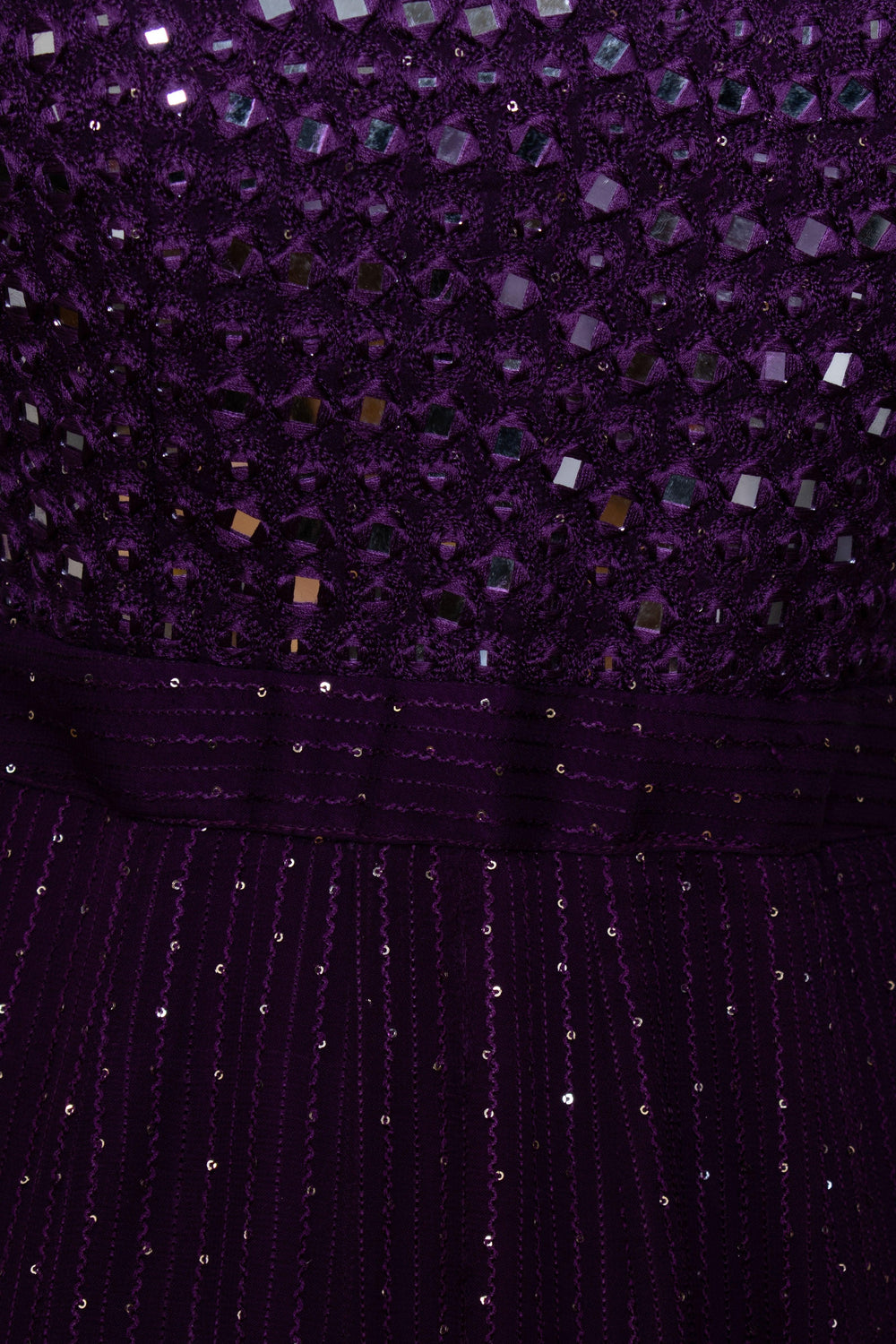 Close-up of a wine georgette gown with mirror embroidered torso and sequined lower half.