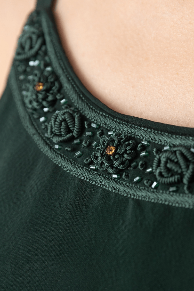 Close-up of a Mirena Green A-Line Long Dress, showcasing intricate resham embroidery and beads on the silk neckline.