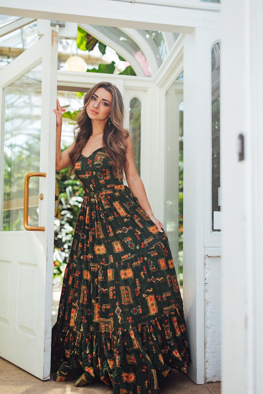 Green rayon maxi gown with ethnic motif print, sweetheart neckline, cinched waist, and tiered skirt.