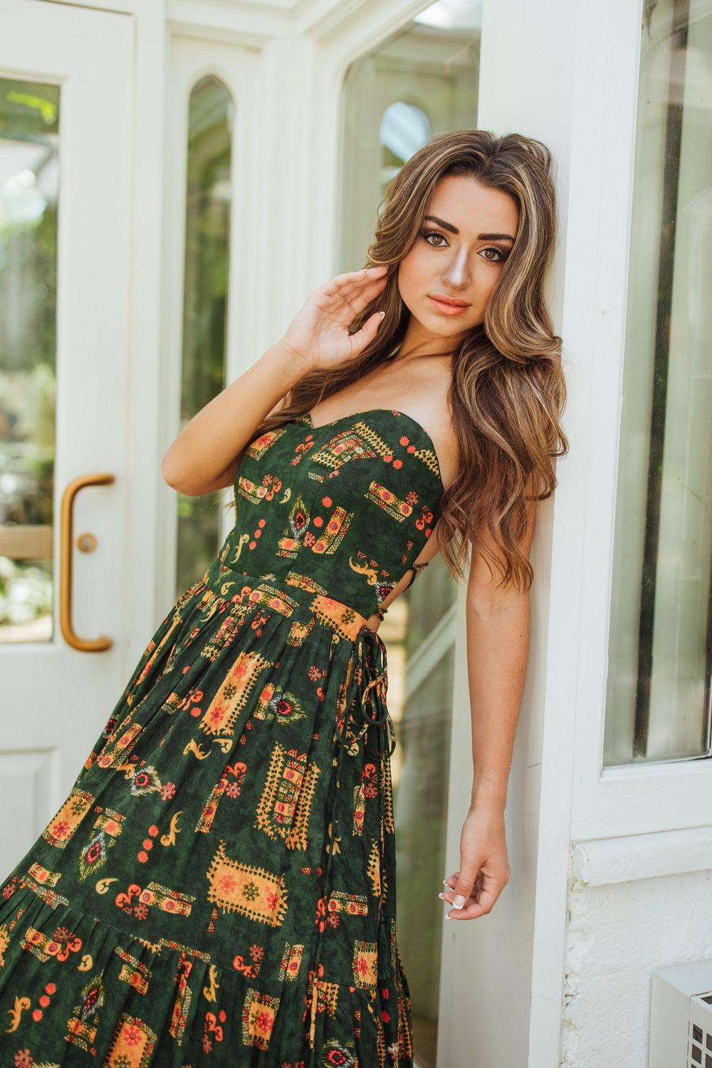 Green rayon convertible maxi gown with ethnic motif print, sweetheart bodice, and tiered skirt.