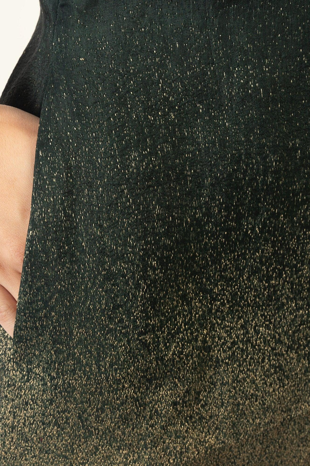Green jacquard silk blazer dress with a golden transition at the hem and sleeve, featuring a hand in the pocket.