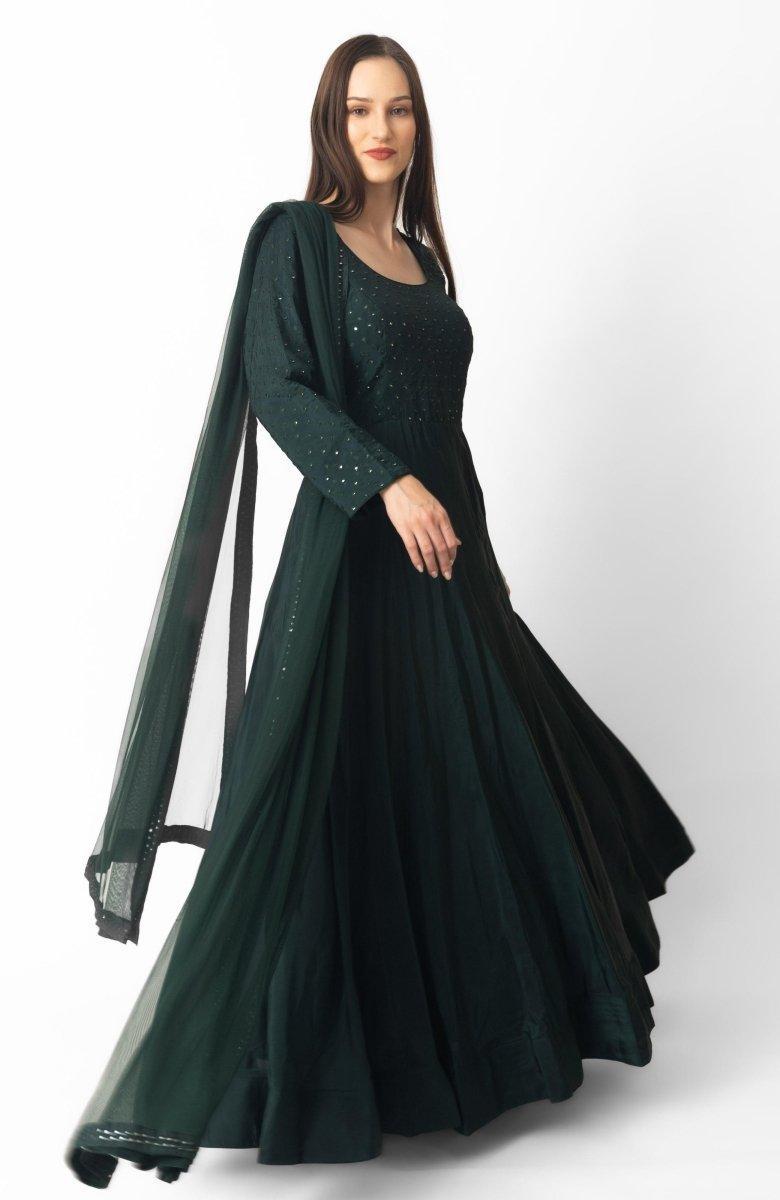 Model wearing a full-sleeved green silk gown with mirror embroidery and a matching net dupatta.