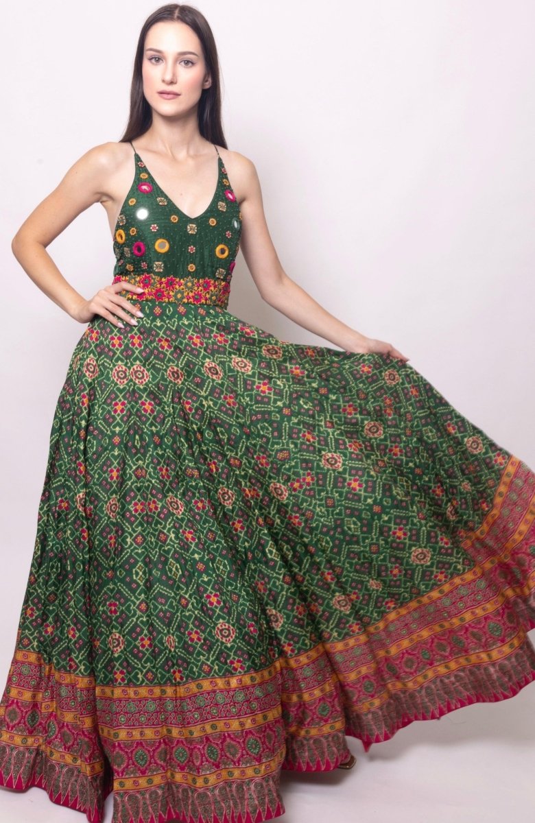 Green silk open-back gown with hand-embroidered halter bodice and patola-patterned skirt.