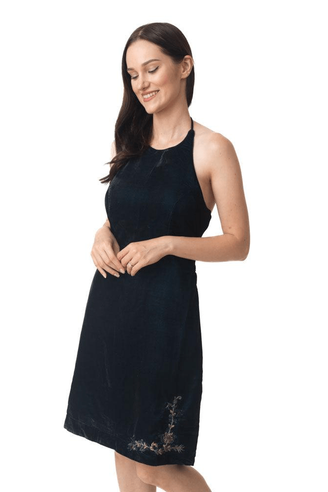 Black velvet halter mini dress with subtle hand embroidery near the hem.