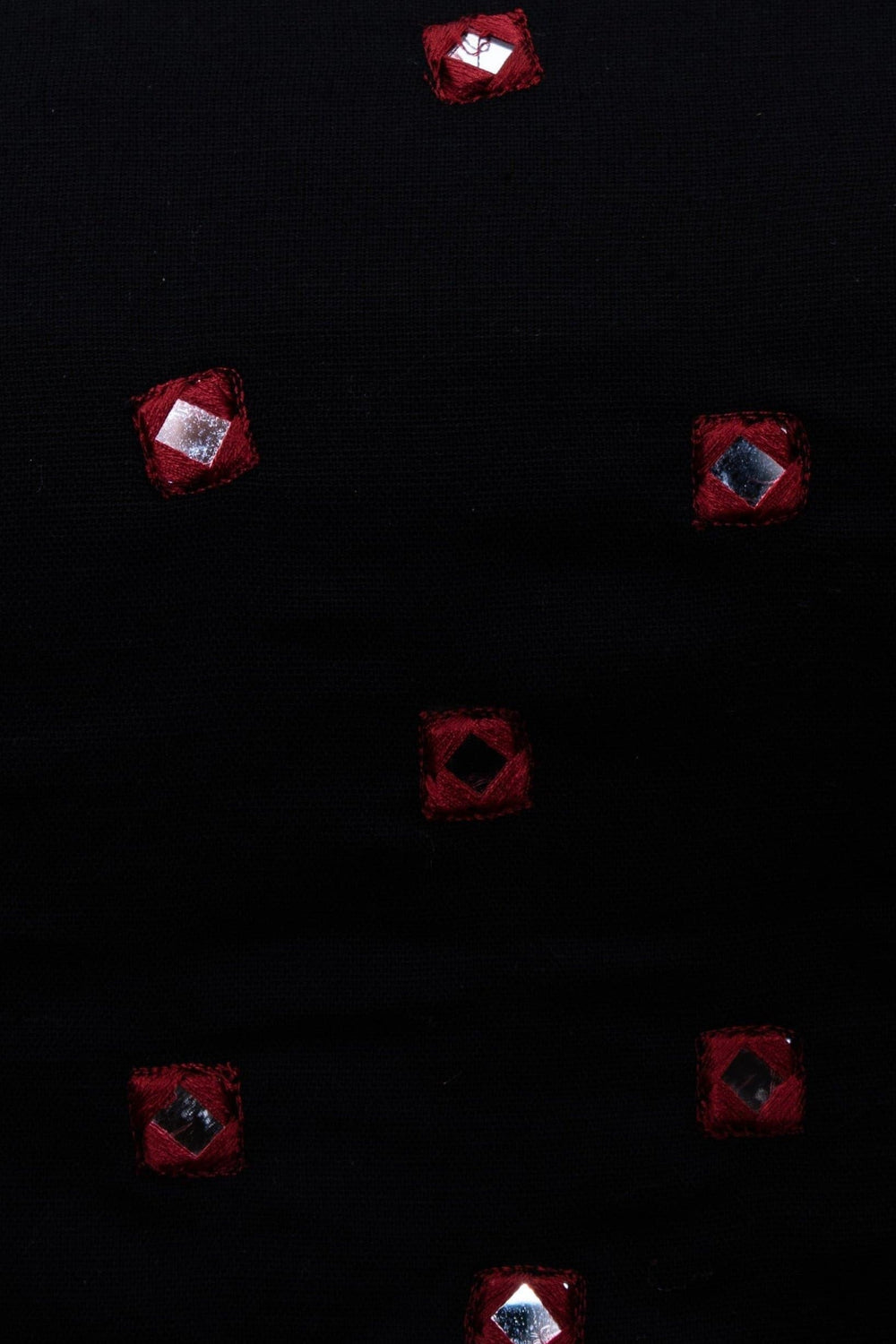 Black cotton fabric with scattered red hand-embroidered mirror work, perfect for Garba styles.