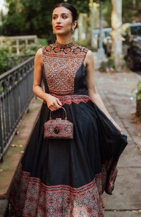 Black silk high neck long dress with intricate resham and stone hand embroidery on the neckline, torso, and hem.