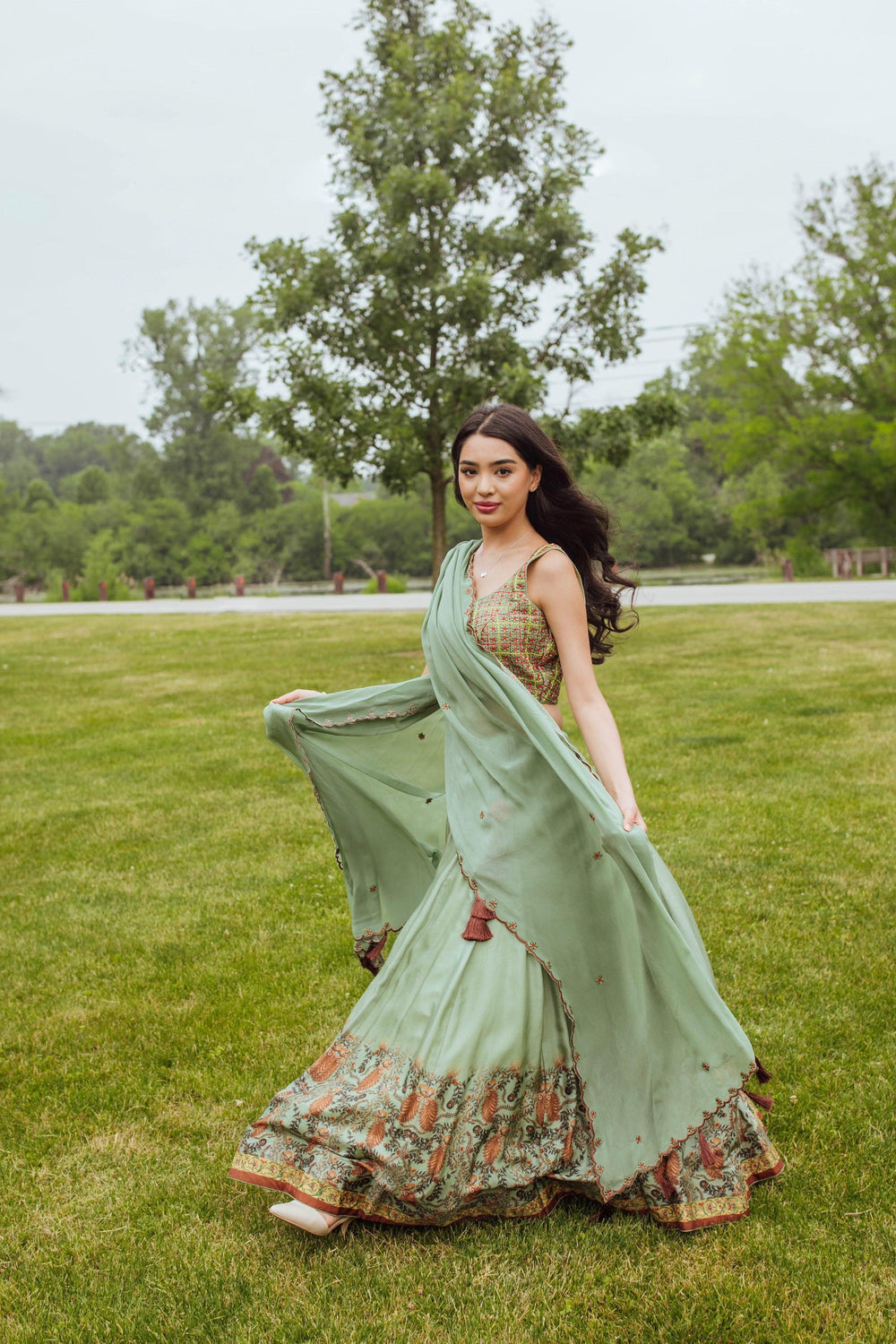 Close-up of embroidery detail on pista green lehenga blouse