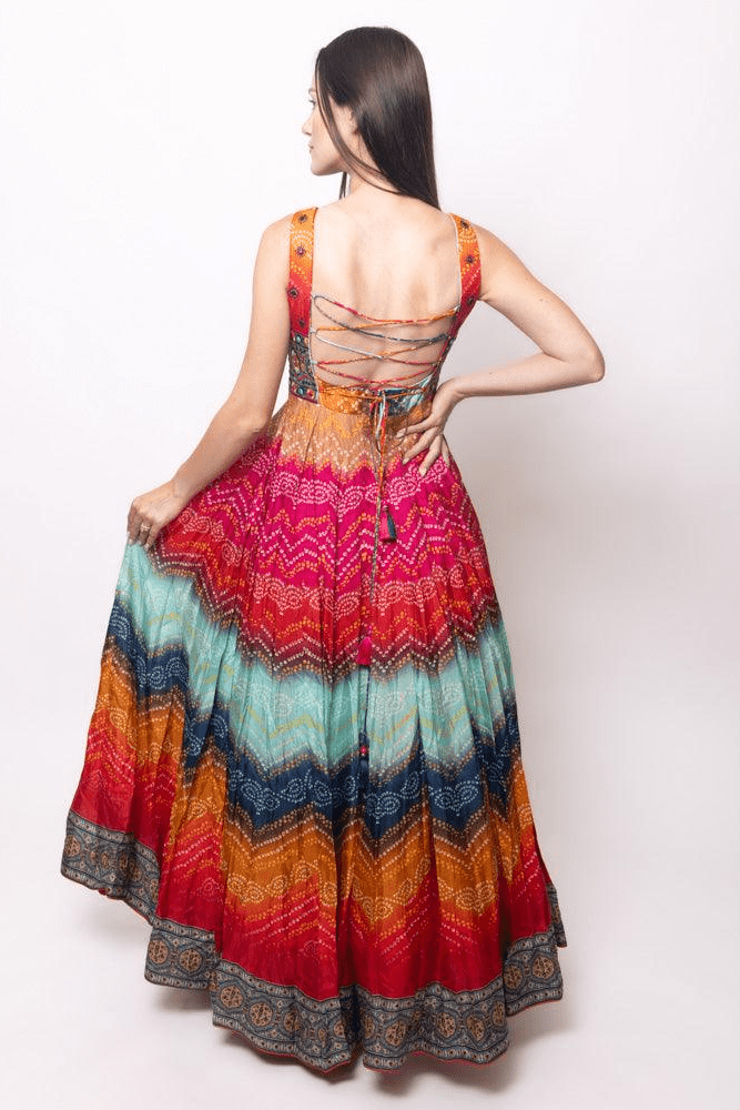 Silk long dress with vibrant bandhani print, v-neck, sleeveless, and lace-up back.