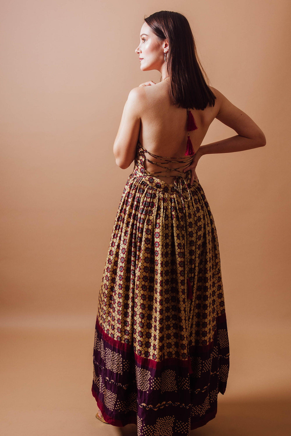 Ema Long Dress: gaji silk, hand-blocked ajrakh print, halter neckline, backless design with tassels.