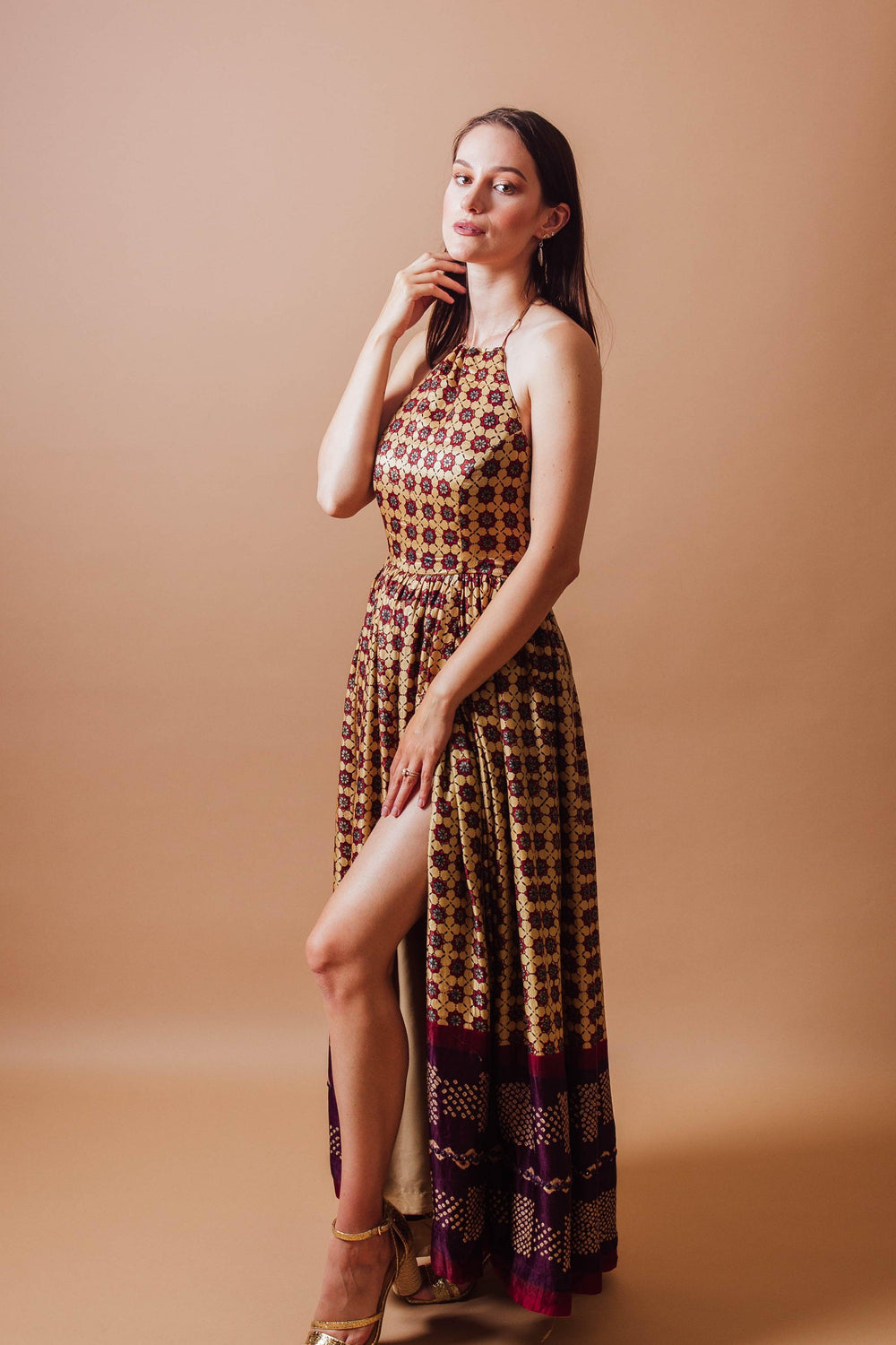 Ema Long Dress: Gaji silk, hand-blocked ajrakh print, halter neckline, left leg slit.