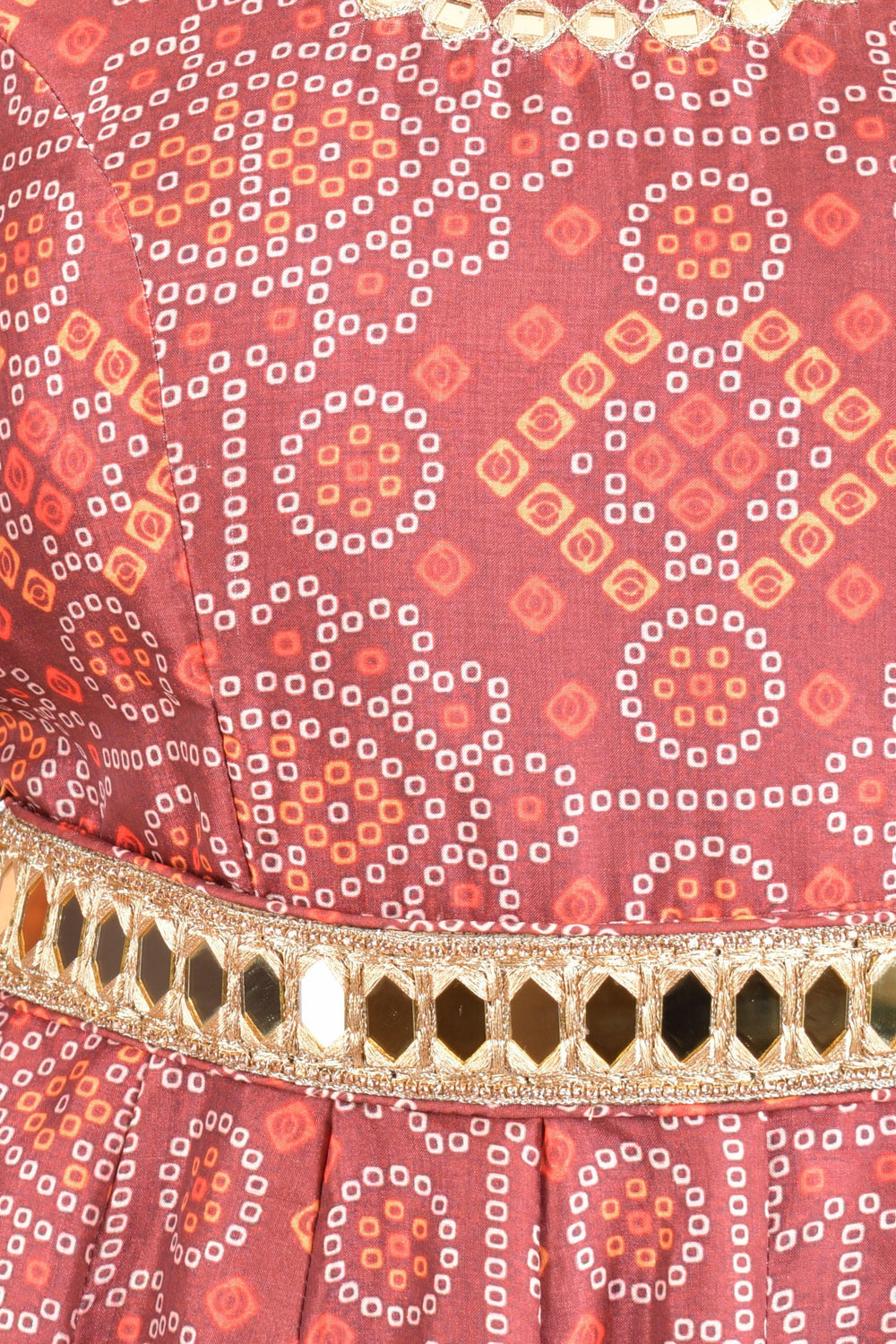 Close-up of a maroon silk Bandhani gown with a golden mirror belt.