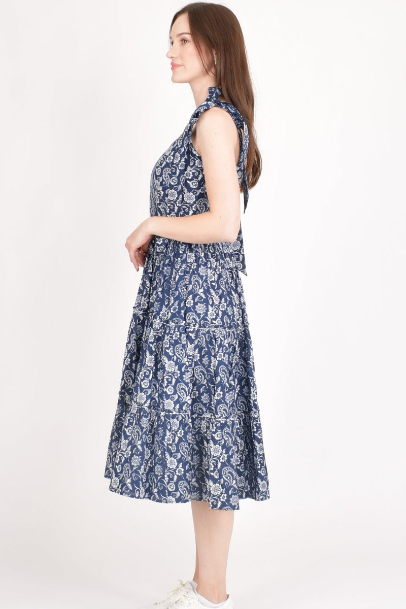 Mila Blue Tiered Midi Dress: cotton, floral print, bow-tie shoulder straps, fit-and-flare silhouette.