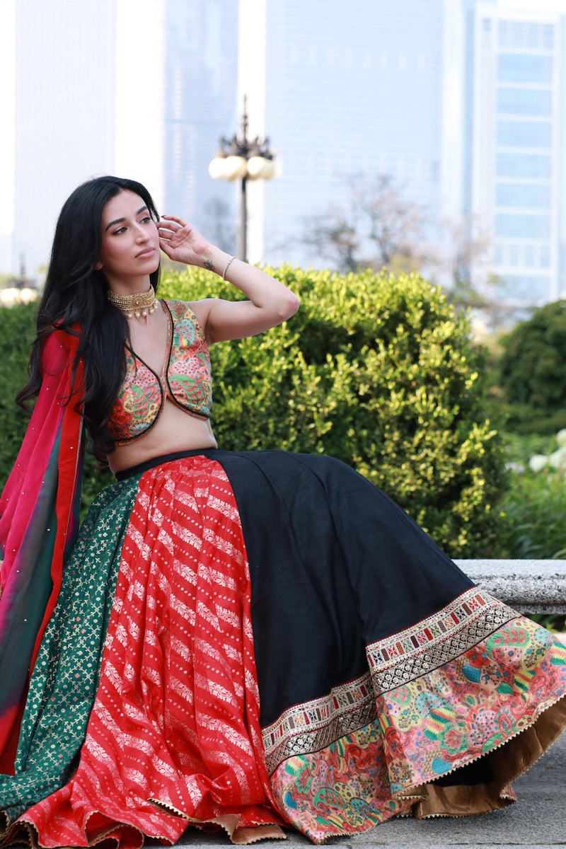 Multi-color full flare Chaniya Choli set with black, red, green panels, embroidered blouse, and tie-dyed dupatta.