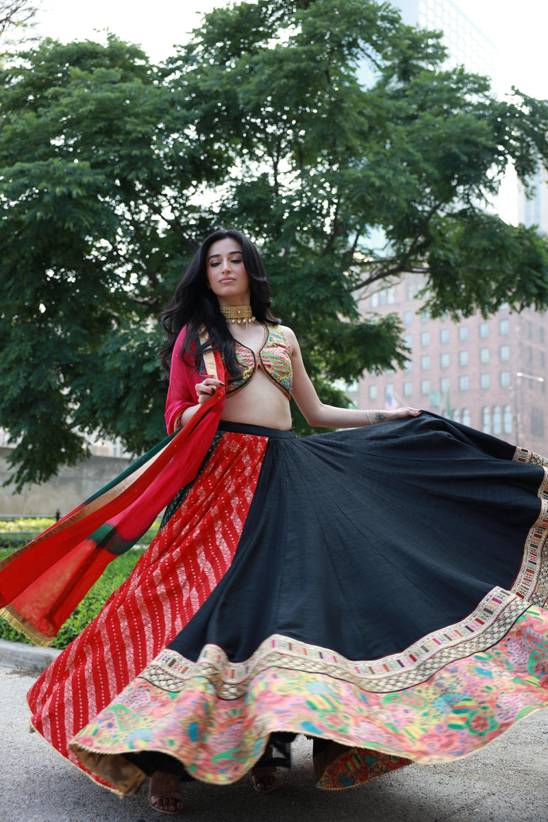 Multi-color full flare Chaniya Choli set with black, red, green, pink panels, embroidered blouse, and tie-dyed dupatta.