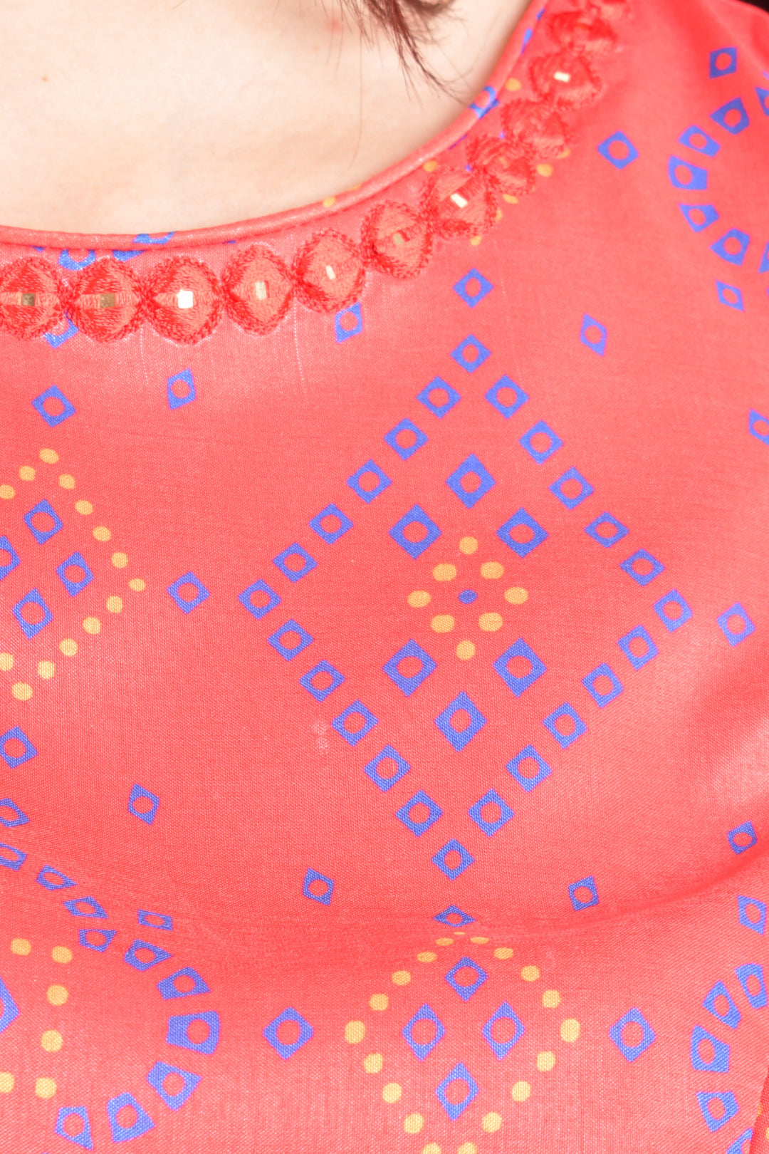 Close-up of a pink fabric with blue and yellow geometric patterns