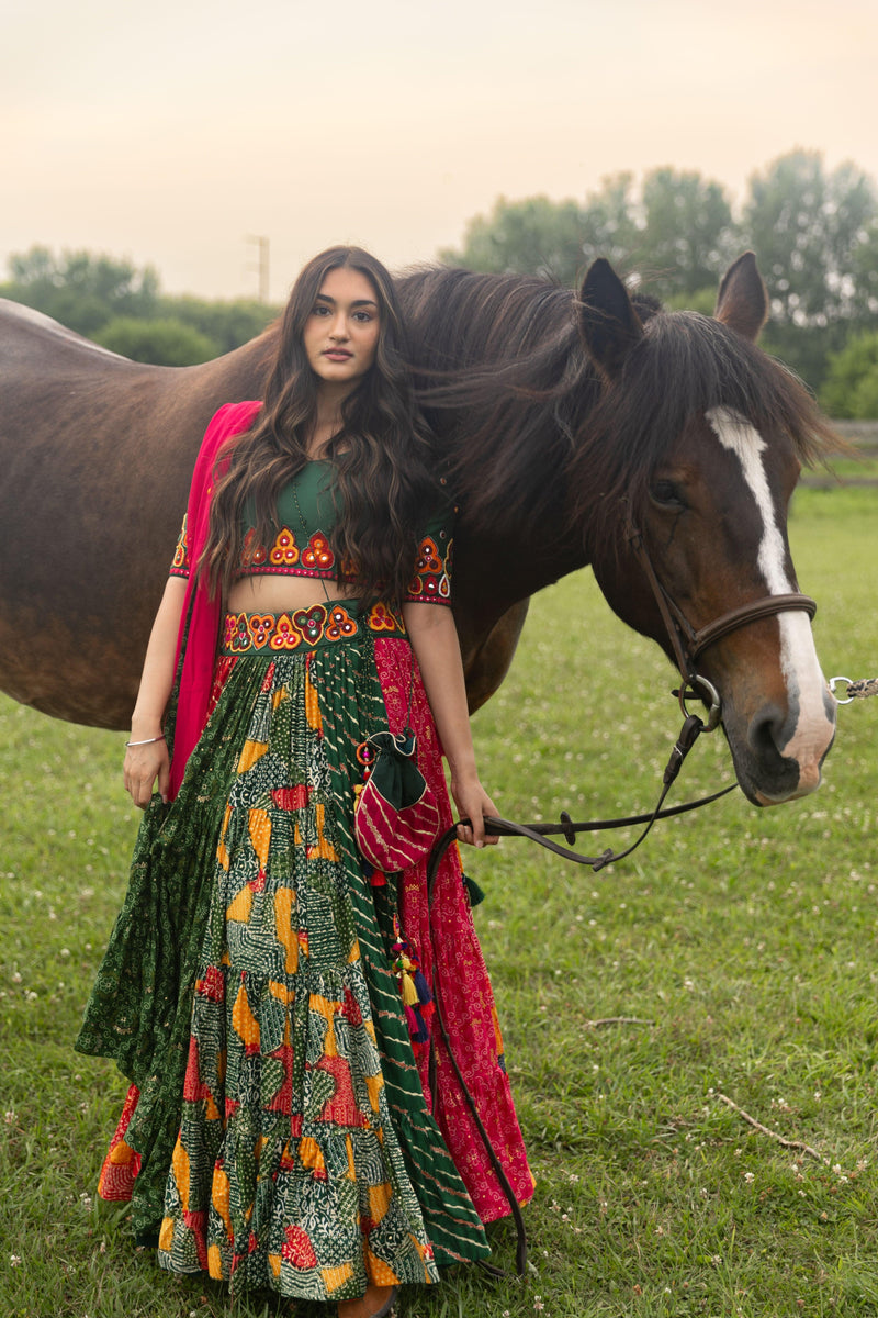 Multicolor full flare Chaniya Choli set with kachi embroidery, U-back blouse, and georgette dupatta, next to a horse.