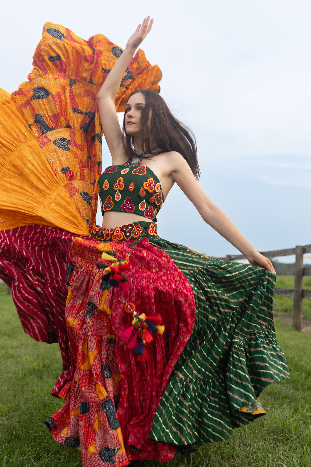 Woman in a multi-color, full-flare Chaniya Choli set, dramatic twirl, Garba style.