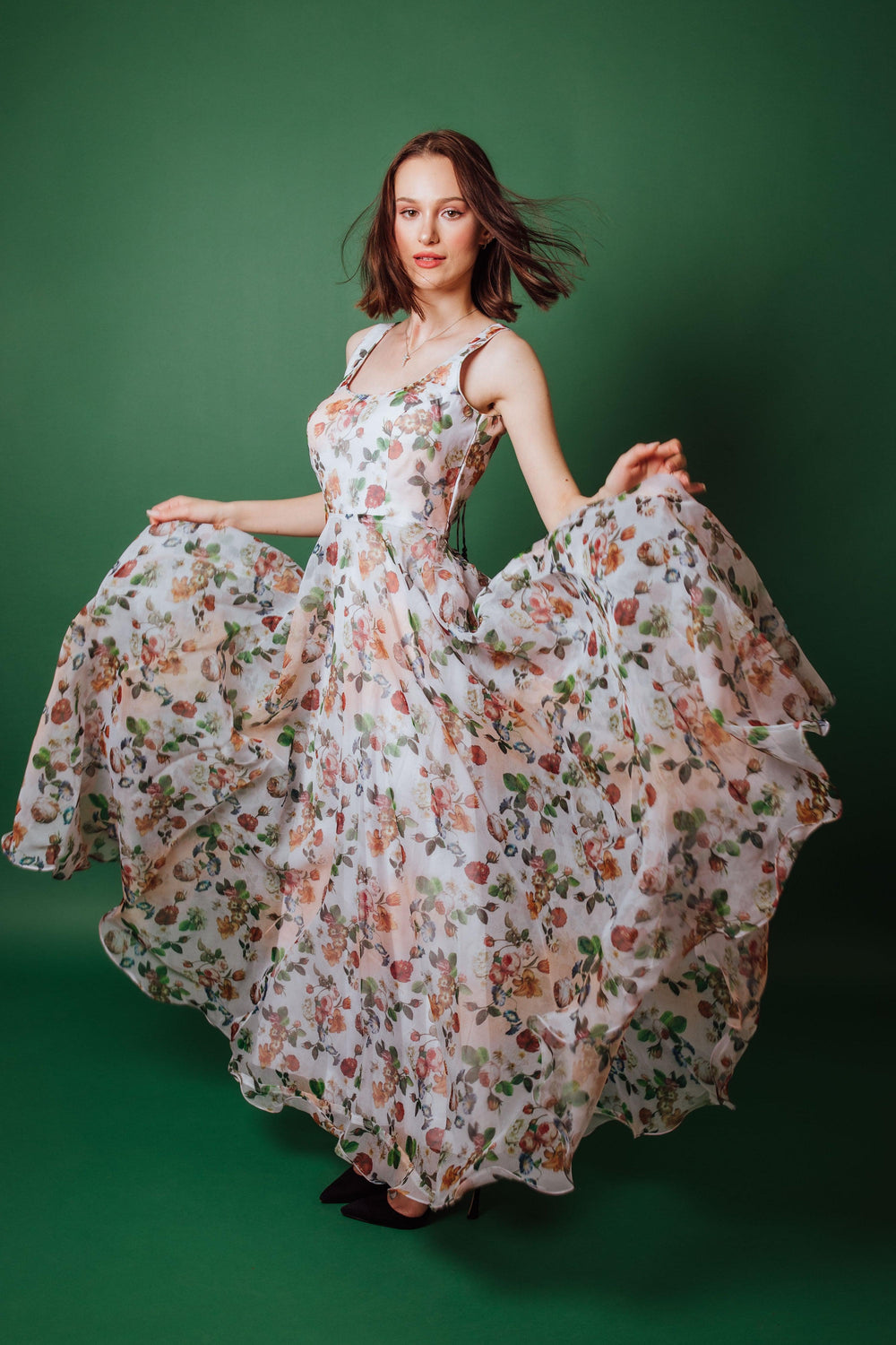 Oranga Floral Printed Gown: White organza gown with peach, coral, and sage floral print, fitted bodice, and full skirt.