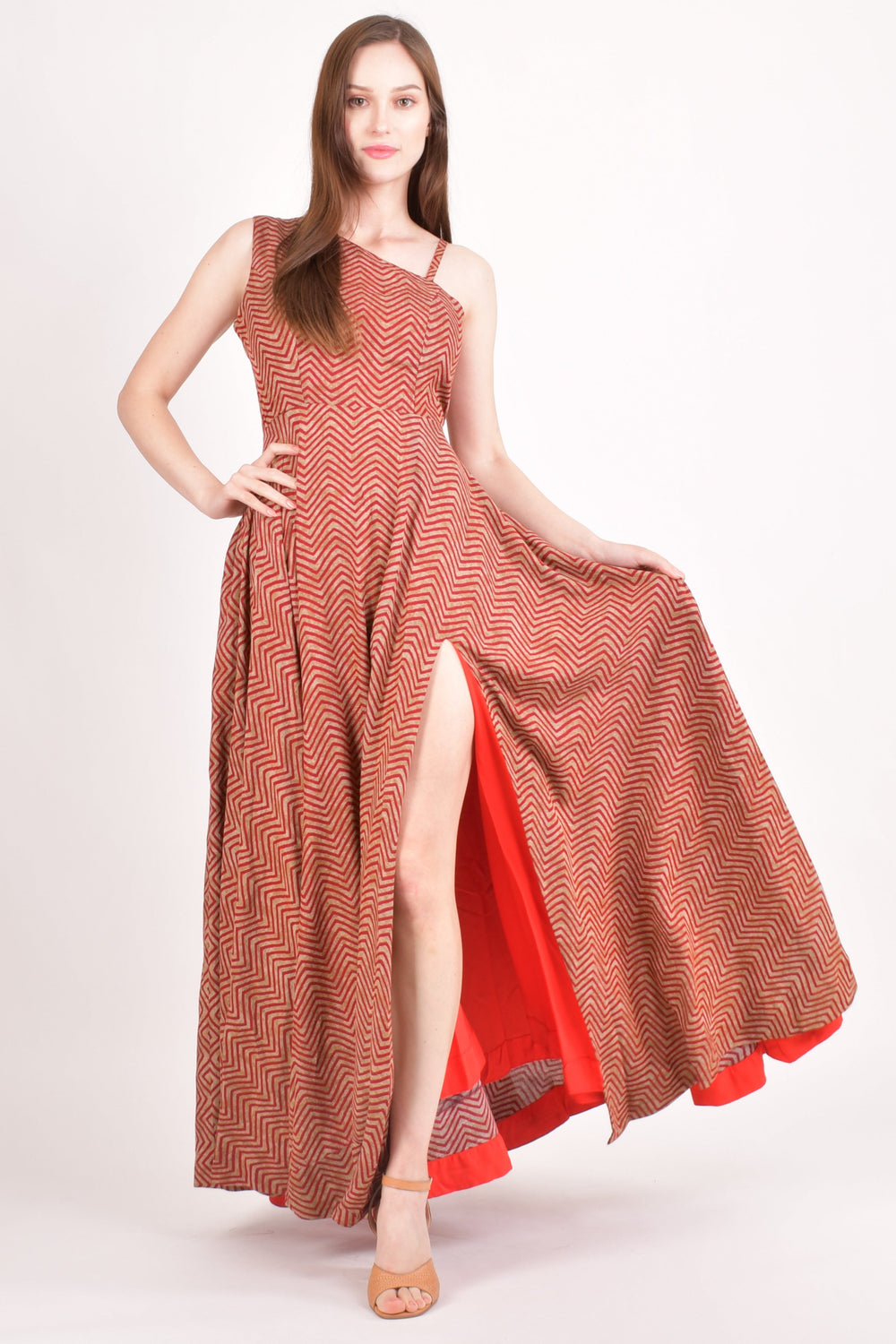 Model wearing an orange cotton maxi dress with subtle stripe patterns, a side slit, and butterfly sleeves.