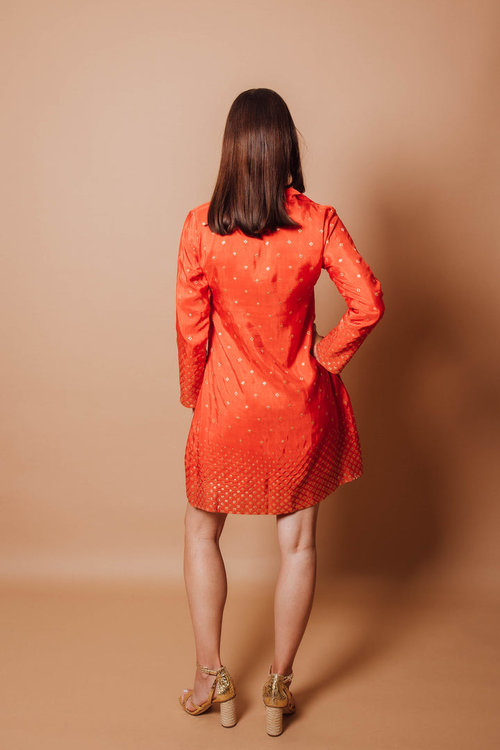 back photo of a model wearing orange blazer dress