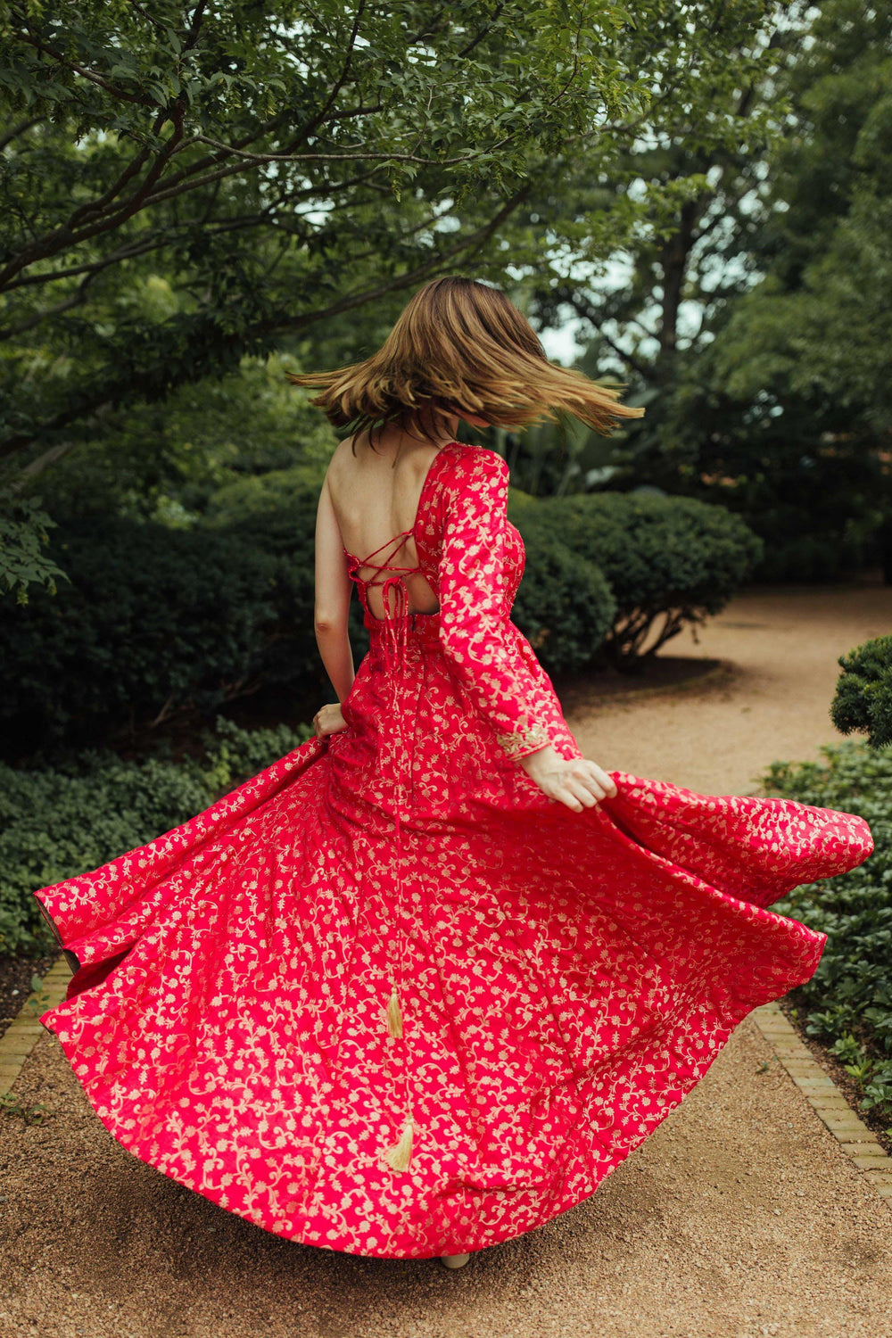 Pink one-shoulder silk brocade gown with all-over patterns and hand-embroidered neckline, flowing A-line skirt.