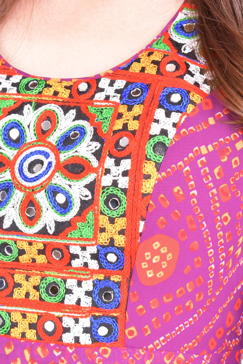 Close-up of a purple georgette maxi dress with intricate Kutchi hand embroidery and mirror work on the neckline.