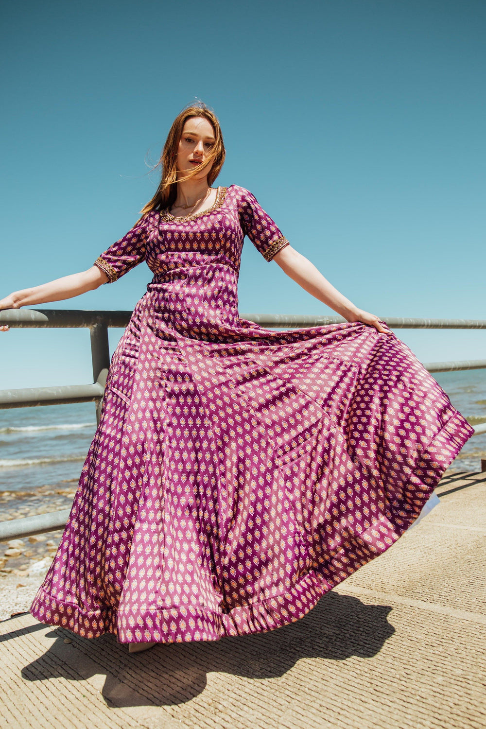 Purple embroidered silk A-line gown with half sleeves, flowing skirt, and intricate zardoshi, stone, resham work.
