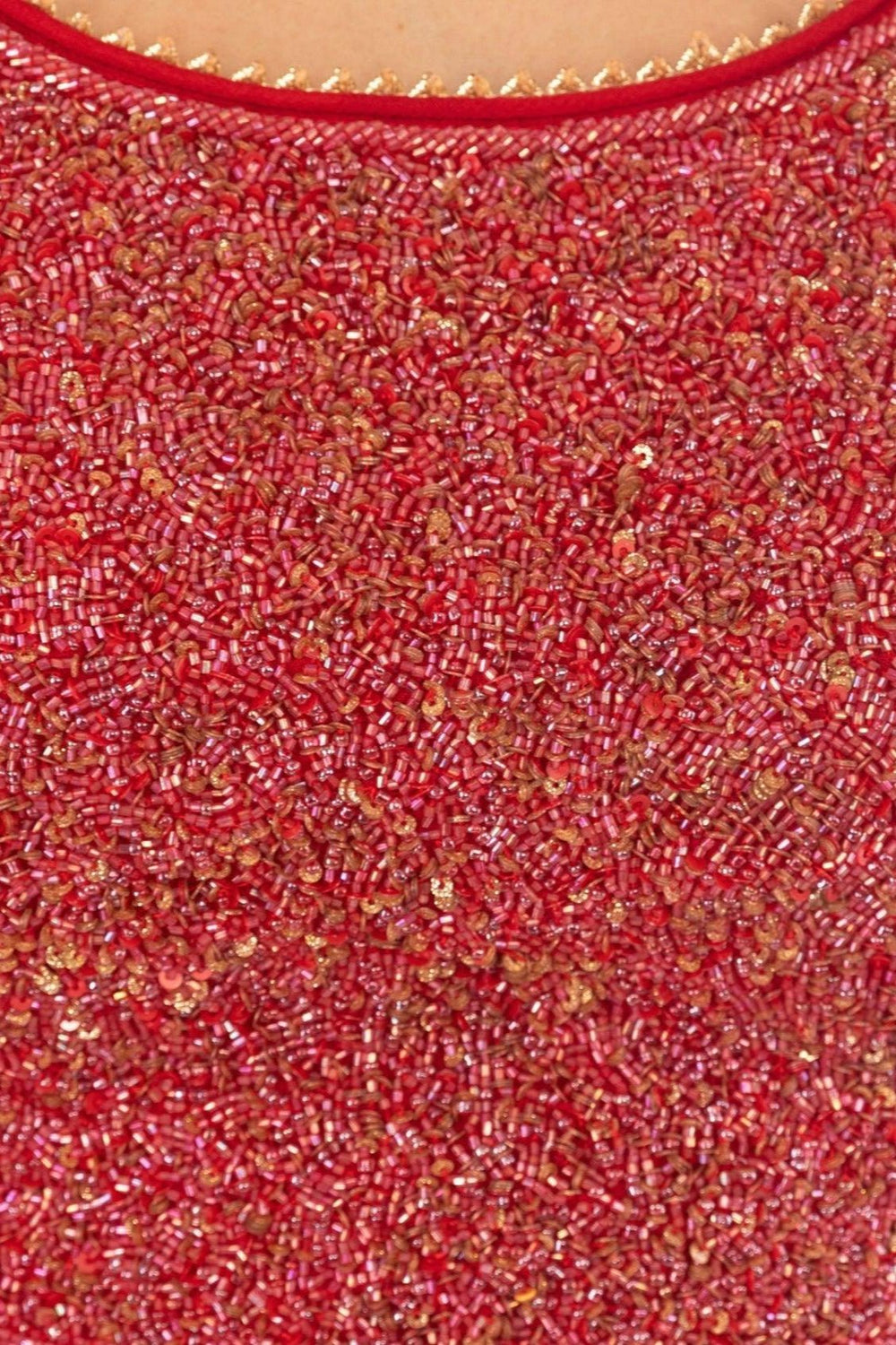 Close-up of a maroon georgette gown's heavily embroidered torso with red beads and gold sequins.