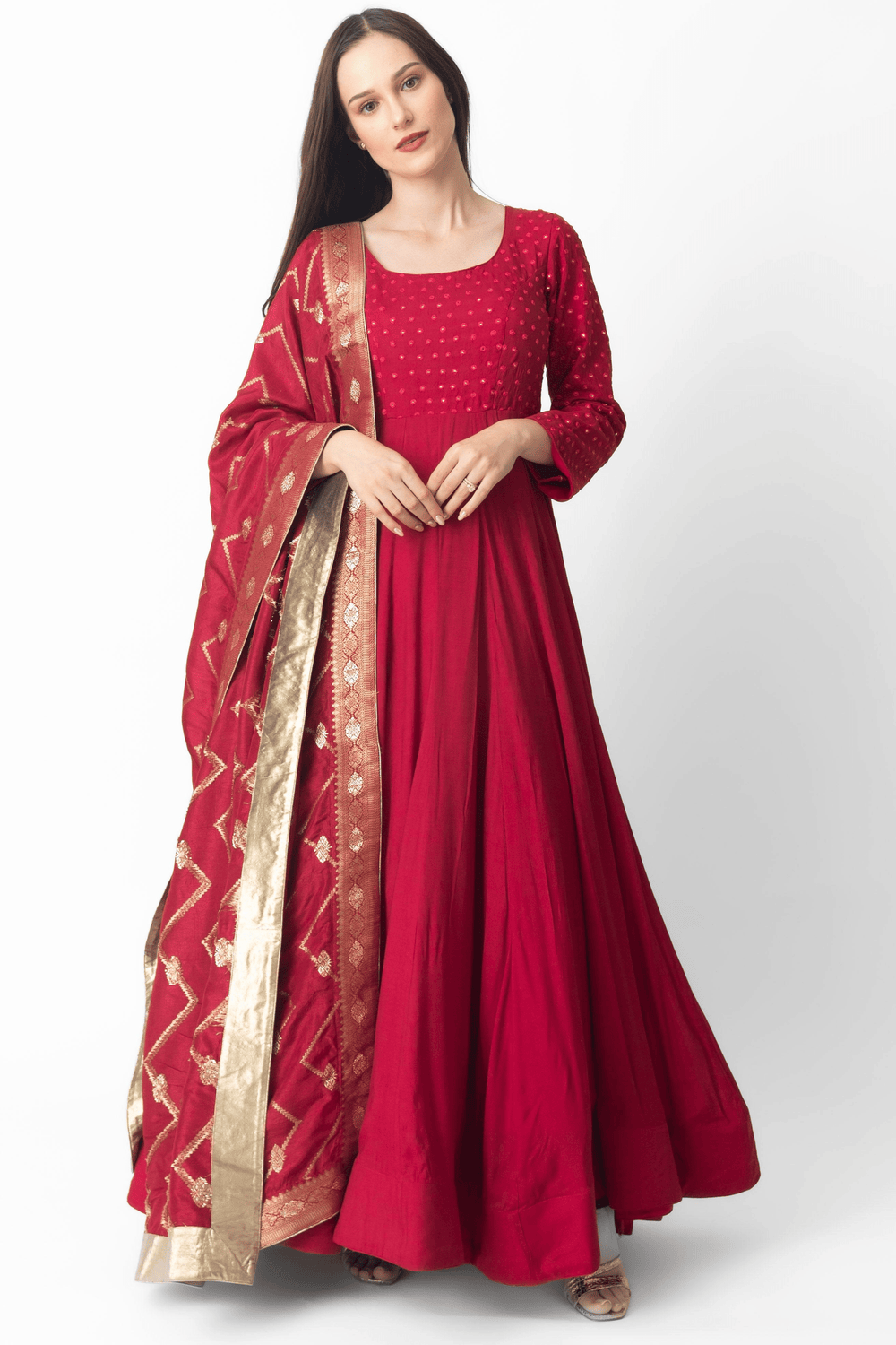 Red silk gown with intricate mirror embroidery, full sleeves, and a matching Banarasi dupatta.