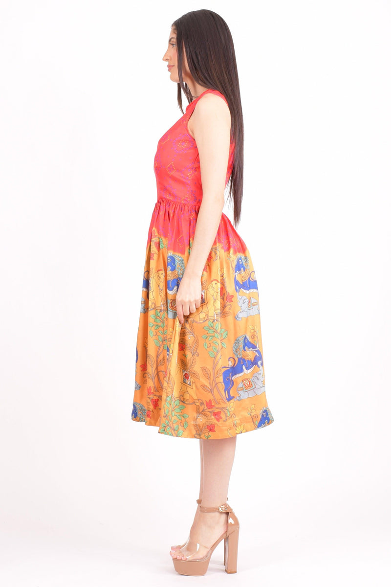 Red silk midi dress with mirror embroidered neckline and floral motifs, vibrant yellow bottom.