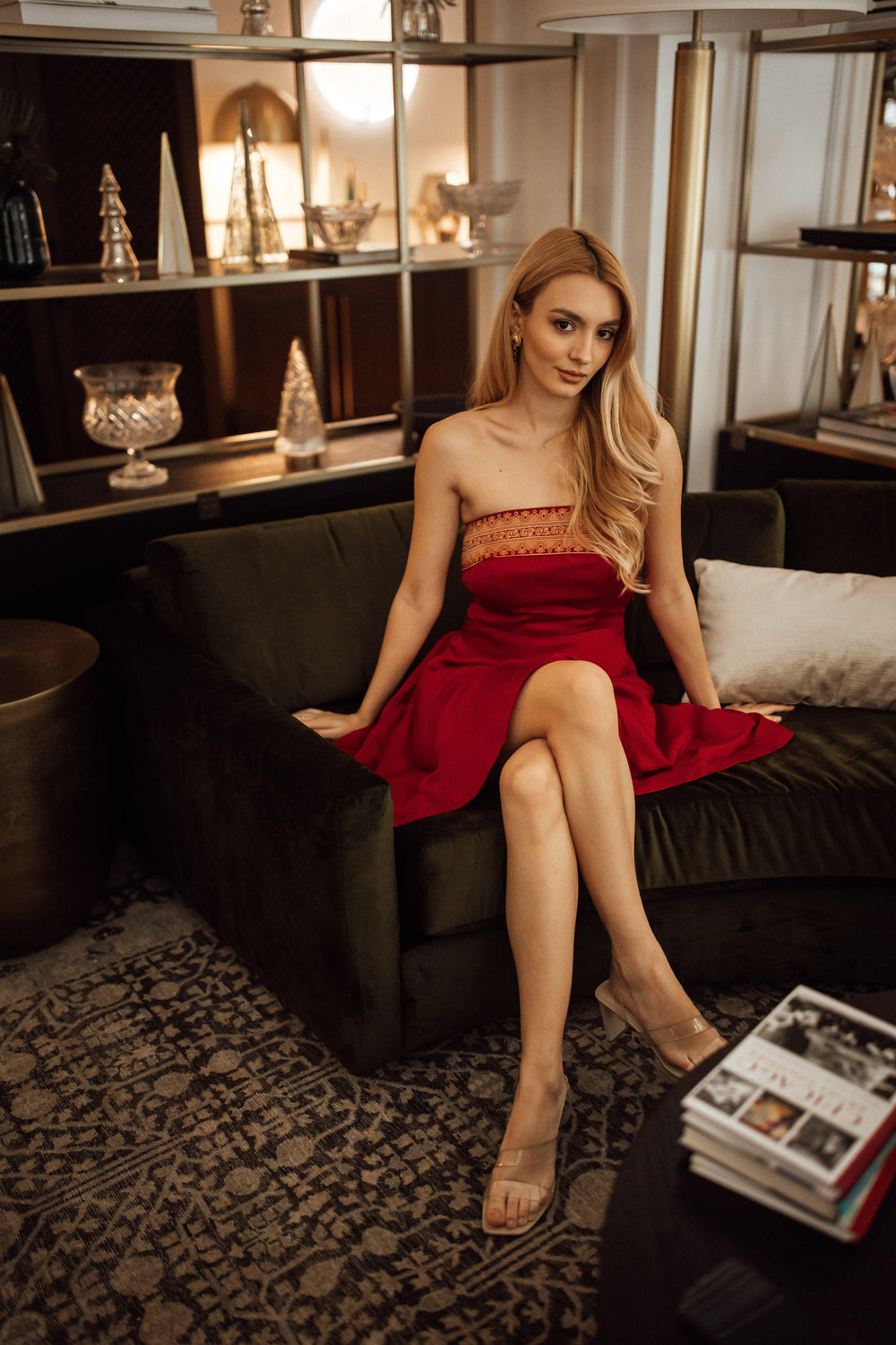 Red silk strapless mini dress with gold jacquard weaving, worn by a blonde model.