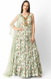 Sage green georgette gown with all-over embroidery, V-neck, and matching net drape.