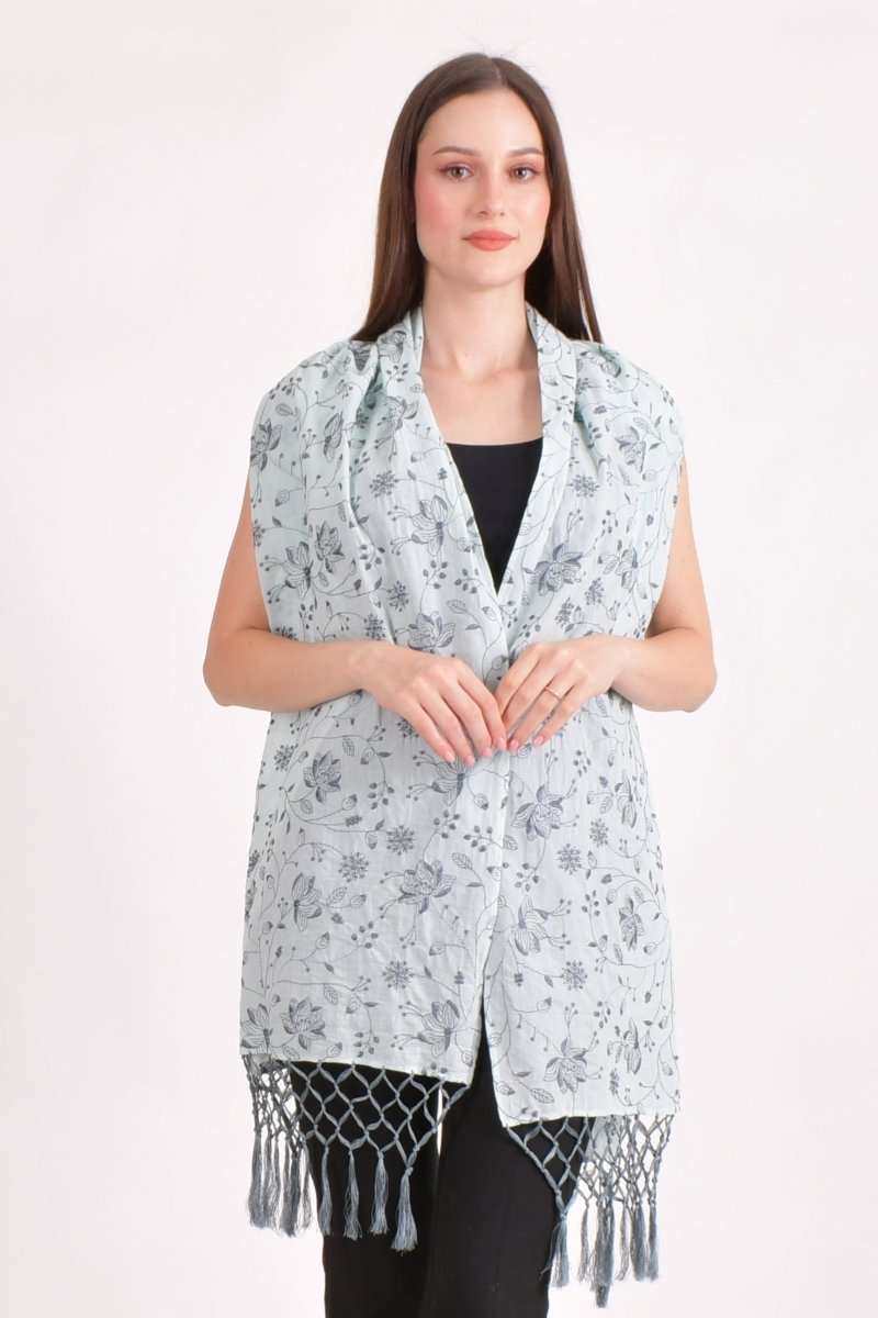 Sage green mul cotton scarf wrap with all-over floral embroidery and handcrafted tassels, perfect for comfort and travel.