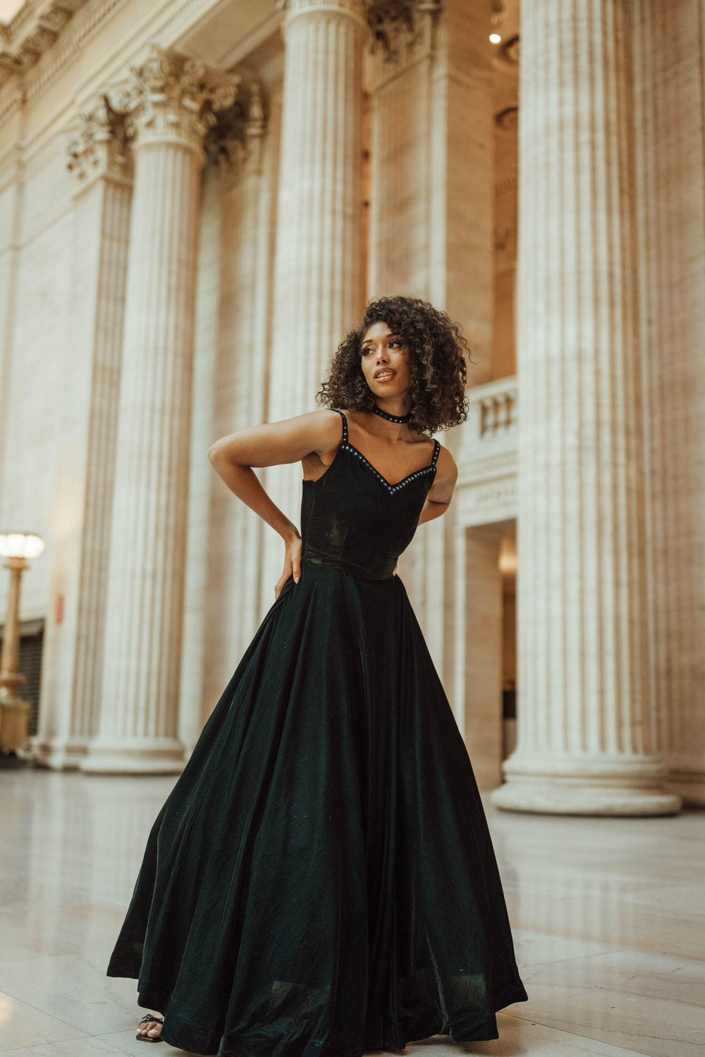 Teal embroidered velvet A-line gown with mirror embroidery on neckline and straps.