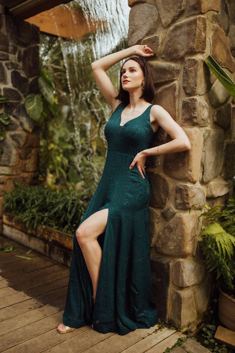 Teal georgette long dress with sequin embroidery, V-neck, sleeveless design, and a bold front slit.