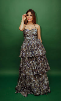Silk tiered floral convertible long dress with micro-pleating, worn over shoulders.