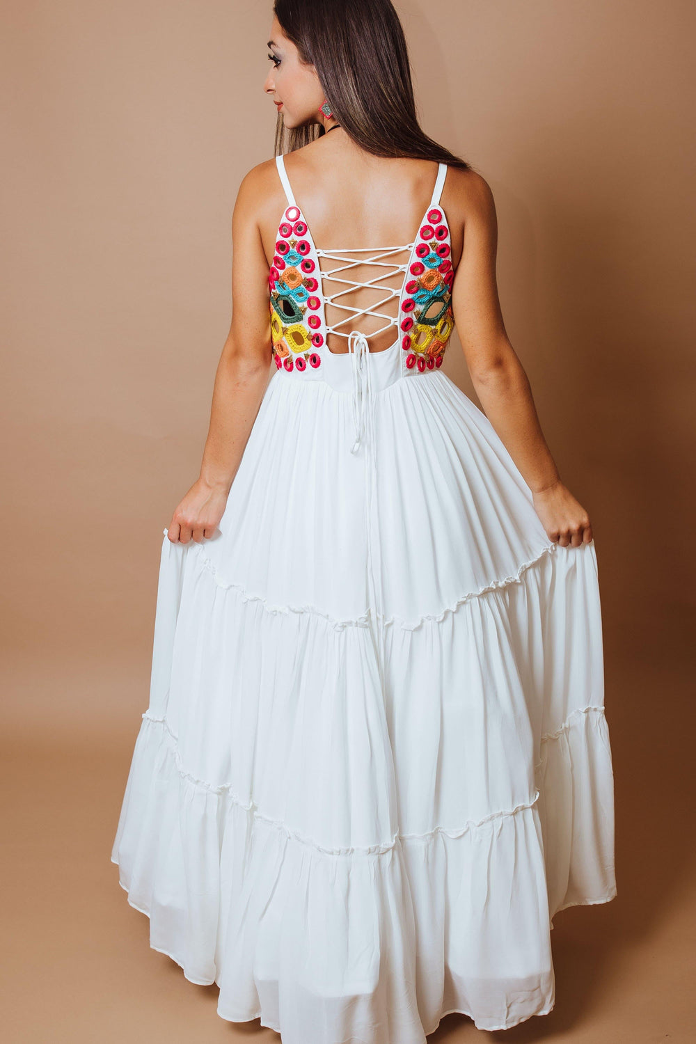 White tiered georgette gown with vibrant anchor and mirror work bodice, lace-up back detail.