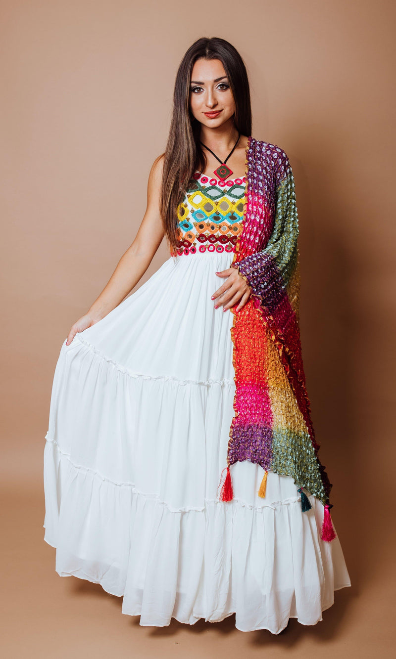 White tiered georgette gown with vibrant anchor and mirror work bodice, paired with a multicolor ombre silk drape.