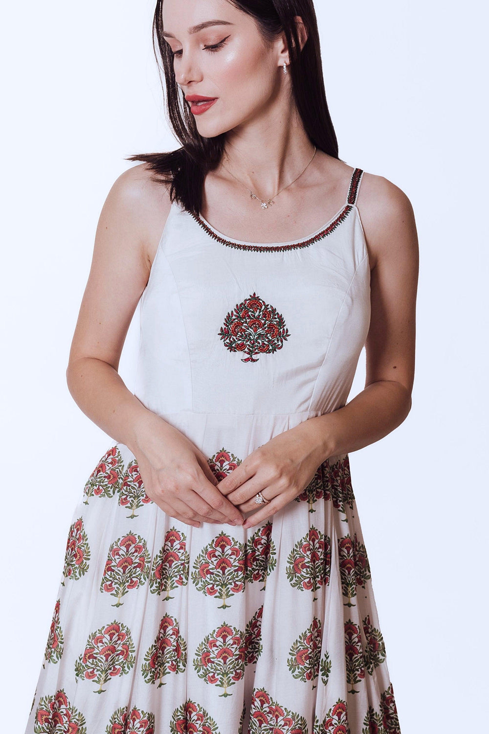 White silk Ajrakh print gown with embroidered neckline and floral printed skirt.