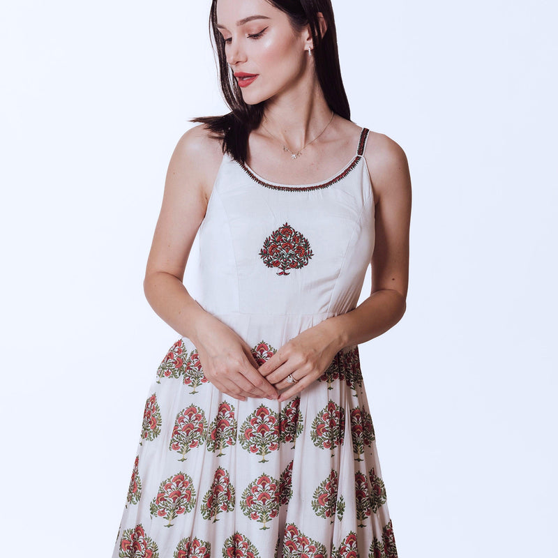 White silk Ajrakh print gown with embroidered neckline and floral printed skirt.