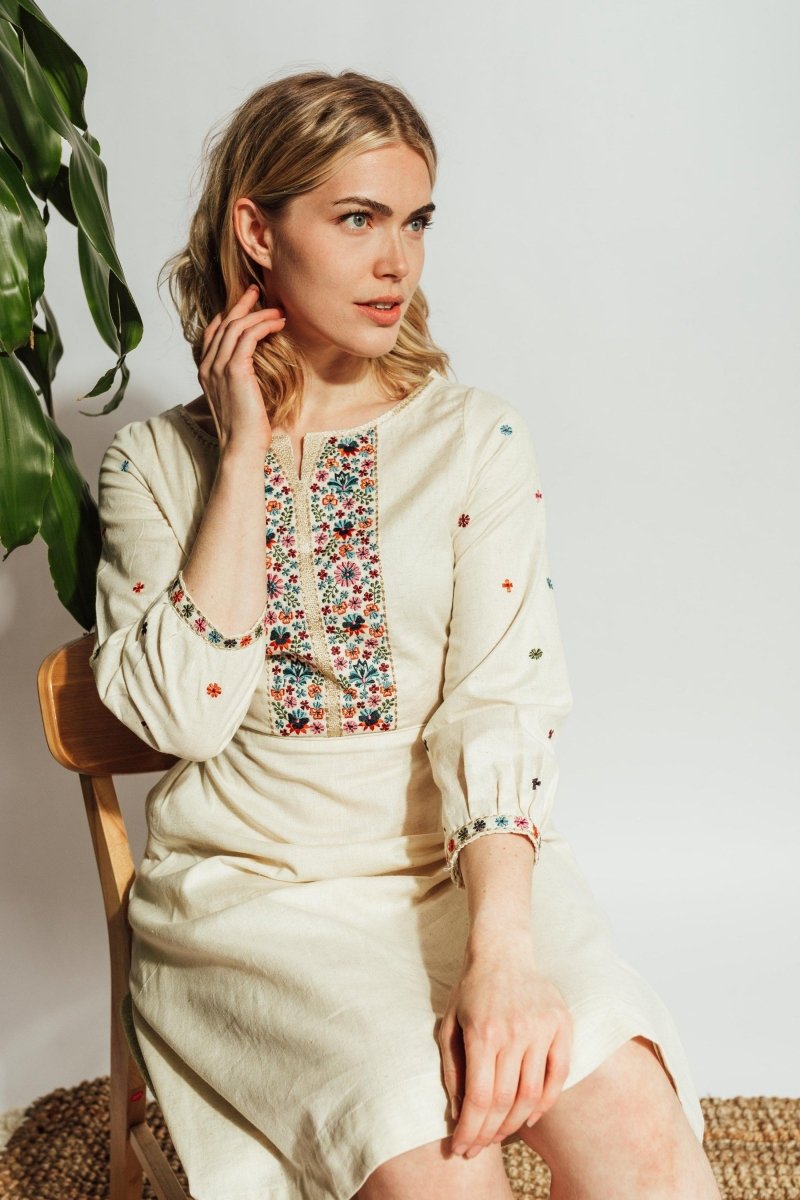 Off-white flex cotton midi dress with colorful floral thread embroidery on sleeves and torso.