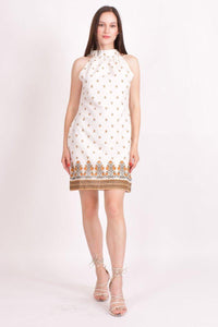 White mul cotton mini dress with a high halter neck and orange floral print border.