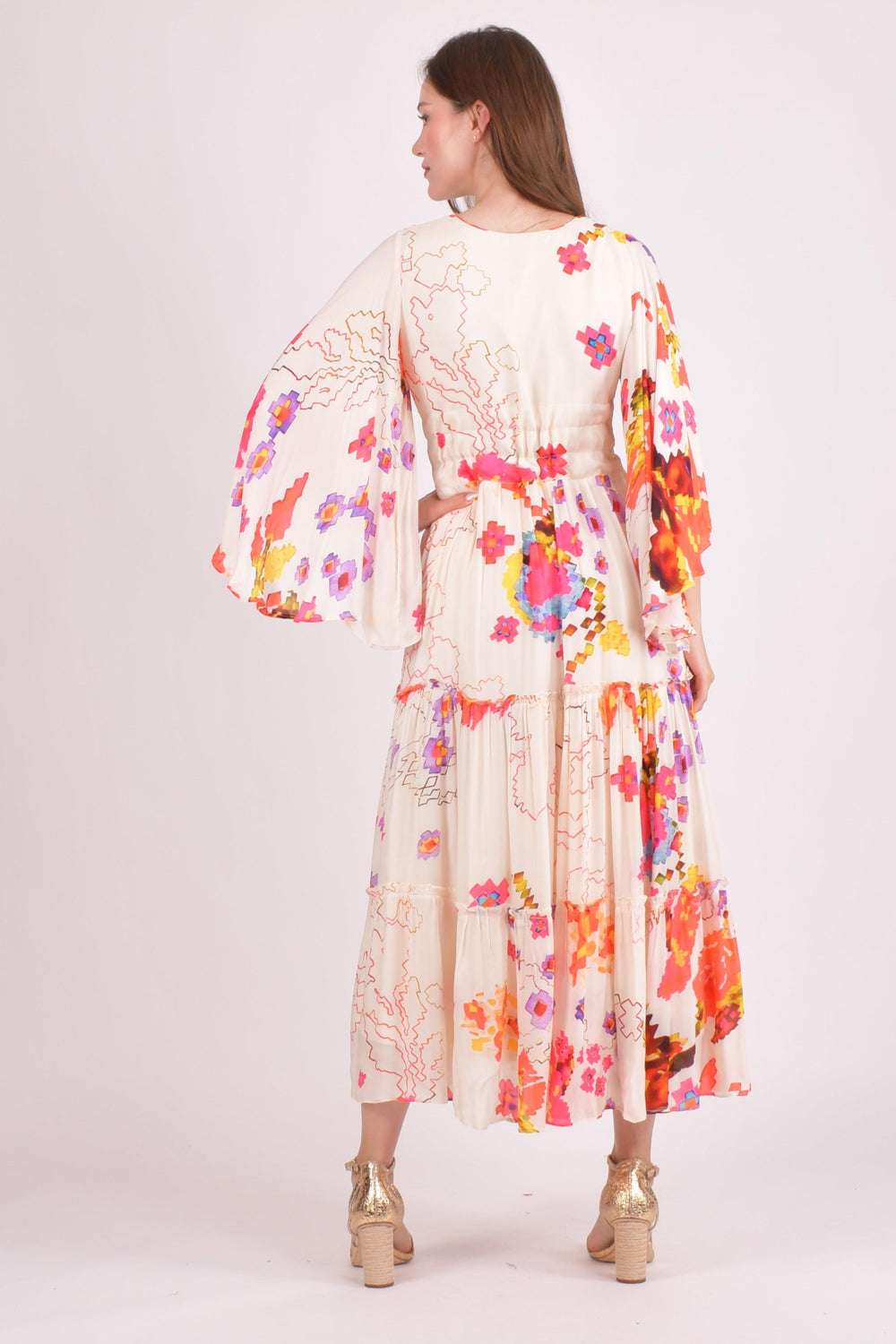 White floral ruffle maxi dress with angel sleeves and colorful watercolor prints.