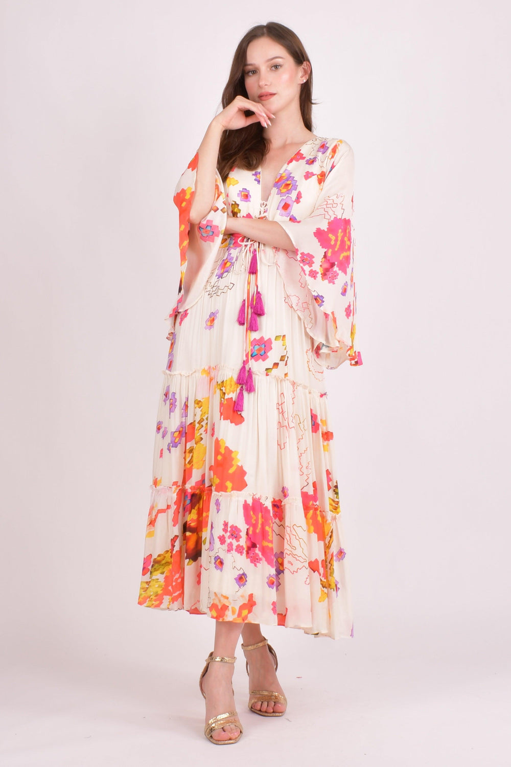 White floral ruffle maxi dress with angel sleeves and tassel tie.