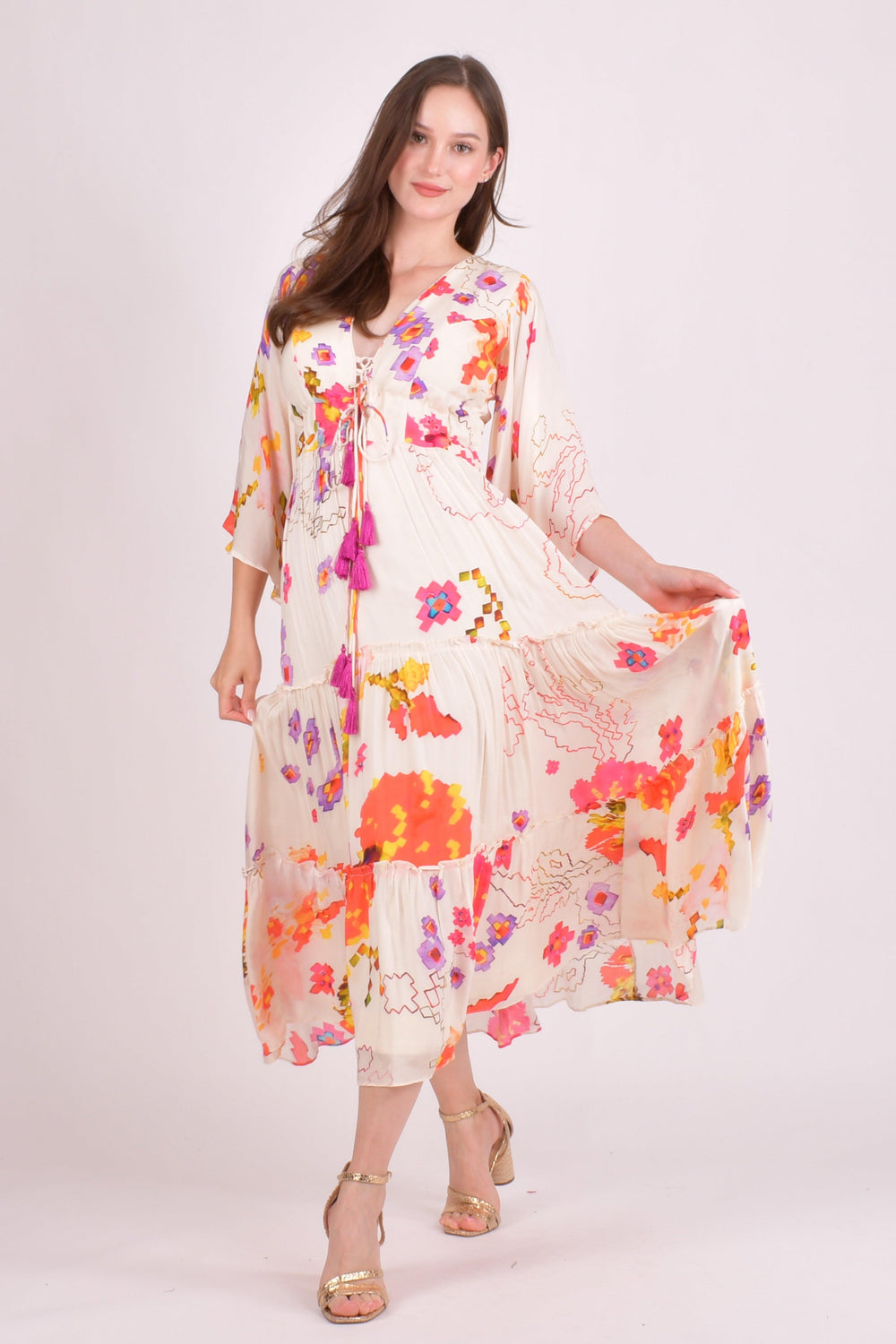 White floral ruffle maxi dress with watercolor prints, angel sleeves, and tassel details.