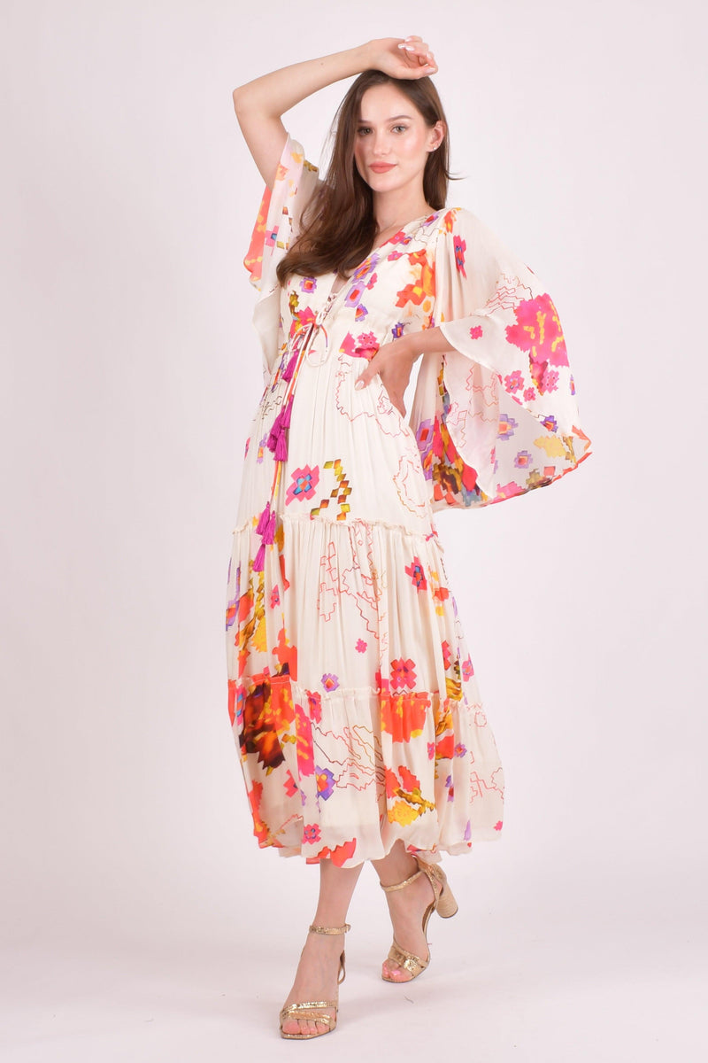 White floral ruffle maxi dress with angel sleeves and watercolor prints.
